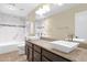 Bright bathroom with dual vessel sinks, granite countertops, and tiled shower/tub at 1617 E Fremont Rd, Phoenix, AZ 85042