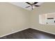 Bedroom featuring dark laminate flooring, neutral paint, and window with a ceiling fan at 1617 E Fremont Rd, Phoenix, AZ 85042