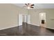 Bedroom with hardwood floors, a ceiling fan, and an ensuite bathroom at 1617 E Fremont Rd, Phoenix, AZ 85042