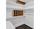 Walk-in closet with custom shelving and dark laminate flooring at 1617 E Fremont Rd, Phoenix, AZ 85042