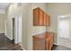 Hallway featuring built-in cabinets and multiple doorways, creating flow and storage at 1617 E Fremont Rd, Phoenix, AZ 85042