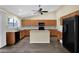 Bright kitchen with wood cabinets, a central island, stainless steel appliances, and tiled backsplash at 1617 E Fremont Rd, Phoenix, AZ 85042