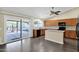 Modern kitchen with wood cabinets, stainless appliances, granite countertops and a sliding glass door to outside at 1617 E Fremont Rd, Phoenix, AZ 85042
