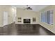 Spacious living room featuring a cozy fireplace, built-in shelving, and natural light from the window at 1617 E Fremont Rd, Phoenix, AZ 85042