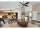 Open-concept living room with hardwood floors, ceiling fan, and kitchen view at 1617 E Fremont Rd, Phoenix, AZ 85042