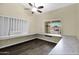 Office with built in shelves and desk with a ceiling fan and wood laminate floors at 1617 E Fremont Rd, Phoenix, AZ 85042