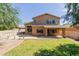 Large backyard featuring a hot tub, covered patio, and ample green space at 16228 W Crocus Dr, Surprise, AZ 85379