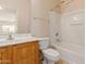 Bright bathroom featuring a tub and shower combo, toilet and vanity with mirror at 16228 W Crocus Dr, Surprise, AZ 85379