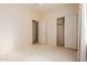 Another bedroom featuring a closet and an open doorway showing another room at 16228 W Crocus Dr, Surprise, AZ 85379