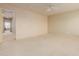 Comfortable bedroom with carpet flooring, ceiling fan, and an attached sitting area at 16228 W Crocus Dr, Surprise, AZ 85379