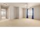 Expansive bedroom with natural light, neutral carpet, and an attached room at 16228 W Crocus Dr, Surprise, AZ 85379