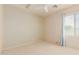 Bright bedroom with a ceiling fan and natural light from a window at 16228 W Crocus Dr, Surprise, AZ 85379