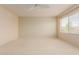 Bright, spacious bedroom featuring plush carpet, a ceiling fan, and large windows for ample natural light at 16228 W Crocus Dr, Surprise, AZ 85379