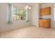 Bright dining area features tile floors, a large window, and simple chandelier lighting at 16228 W Crocus Dr, Surprise, AZ 85379