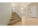 Welcoming entryway featuring tile flooring, staircase, and natural light at 16228 W Crocus Dr, Surprise, AZ 85379