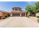 Two-story home with three-car garage and a well-maintained, xeriscaped front yard in a suburban neighborhood at 16228 W Crocus Dr, Surprise, AZ 85379