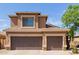 Close up of the house with three garage doors and a window with blue blinds on the second story at 16228 W Crocus Dr, Surprise, AZ 85379