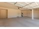A spacious and clean garage interior with ample room for parking and storage at 16228 W Crocus Dr, Surprise, AZ 85379