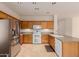Spacious kitchen with stainless steel appliances, and plentiful wood cabinets and countertops at 16228 W Crocus Dr, Surprise, AZ 85379
