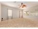 Large living area with tile floors, neutral paint, ceiling fan and multiple windows at 16228 W Crocus Dr, Surprise, AZ 85379