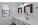 Bathroom featuring dual sinks and a vanity with modern fixtures at 17812 N Carmen Ave, Maricopa, AZ 85139