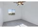 Bedroom with a large window for natural light and ceiling fan at 17812 N Carmen Ave, Maricopa, AZ 85139