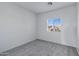 Clean bedroom with neutral walls, gray carpet, and a bright window at 17812 N Carmen Ave, Maricopa, AZ 85139