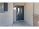 Close-up of the front door with decorative glass, sidelight window, and stone accents, offering curb appeal at 17812 N Carmen Ave, Maricopa, AZ 85139
