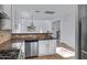 Kitchen boasts stainless appliances, granite counters and a large sink overlooking the living space at 17812 N Carmen Ave, Maricopa, AZ 85139
