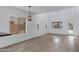 Bright living room featuring high ceilings, many windows, and modern light fixture at 17812 N Carmen Ave, Maricopa, AZ 85139