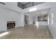 Open floor plan with electric fireplace, staircase, modern lighting and a kitchen with bar at 17812 N Carmen Ave, Maricopa, AZ 85139