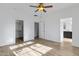 Spacious main bedroom with ceiling fan, walk-in closet, and en-suite bathroom at 17812 N Carmen Ave, Maricopa, AZ 85139