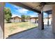 Covered patio overlooking a landscaped backyard with a pergola at 17812 N Carmen Ave, Maricopa, AZ 85139