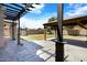 Stylish covered patio offers a view of the backyard and pergola at 17812 N Carmen Ave, Maricopa, AZ 85139