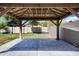 Tranquil backyard showcasing a shaded pergola and paved patio area at 17812 N Carmen Ave, Maricopa, AZ 85139