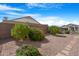 Desert landscaping creates low-maintenance backyard appeal with mature green bushes at 18163 W Addie Ln, Surprise, AZ 85374