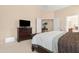 Comfortable bedroom featuring neutral carpeting, a large bed and dresser, and a closet for ample storage at 18163 W Addie Ln, Surprise, AZ 85374