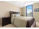 Comfortable bedroom with a large window, a queen bed and bedside tables, and carpeted floors at 18163 W Addie Ln, Surprise, AZ 85374