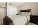 Well-lit bedroom featuring neutral carpeting, a queen-sized bed, and a closet with sliding doors at 18163 W Addie Ln, Surprise, AZ 85374