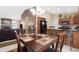 Dining area showcasing a wooden table set, kitchen island, and open living space at 18163 W Addie Ln, Surprise, AZ 85374