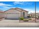 Charming single-story home featuring a well-manicured desert landscape and attached two-car garage at 18163 W Addie Ln, Surprise, AZ 85374