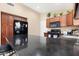 This contemporary kitchen has granite countertops and wooden cabinets at 18163 W Addie Ln, Surprise, AZ 85374