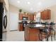 Well-lit kitchen with wood cabinets, granite countertops, and stainless-steel appliances, creating a functional space at 18163 W Addie Ln, Surprise, AZ 85374