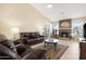 Inviting living room showcasing a fireplace, tiled floors, a ceiling fan, and plush seating at 18163 W Addie Ln, Surprise, AZ 85374