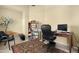 Bright home office with desk, chair, shelving, and a patterned rug at 18163 W Addie Ln, Surprise, AZ 85374