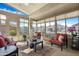 Bright sunroom with multiple windows, comfortable seating, and stylish decor at 18163 W Addie Ln, Surprise, AZ 85374