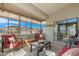 Relaxing sunroom featuring comfortable seating, views, and natural light at 18163 W Addie Ln, Surprise, AZ 85374