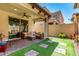 Backyard patio with artificial turf and a cozy seating area at 1930 W Yellowstone Way, Chandler, AZ 85248
