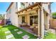 Backyard showing the artificial turf, covered patio, and two story home at 1930 W Yellowstone Way, Chandler, AZ 85248