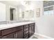 Modern bathroom featuring double sinks with dark cabinets, mosaic tile backsplash, and decorative mirrors at 1930 W Yellowstone Way, Chandler, AZ 85248